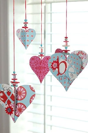 This valentines decoration of paper hearts, beads and buttons is cute for any size house or budget! Also includes more ideas for valentines day decorations to liven up your home decor!