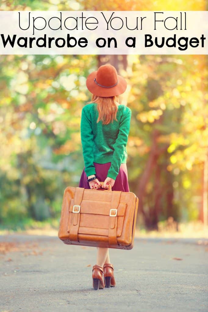 Girl standing with trees with fall leaves around her. She is wearing a green sweater and pink skit, a perfect example of a way to update your fall capsule wardrobe on a budget.