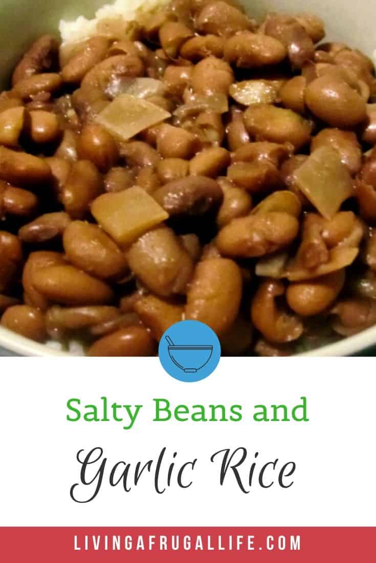 Close up picture of salty beans and garlic rice in a cream colored bowl. There is a text overlay that lasy Salty Beans and Garlic Rice at the bottom.