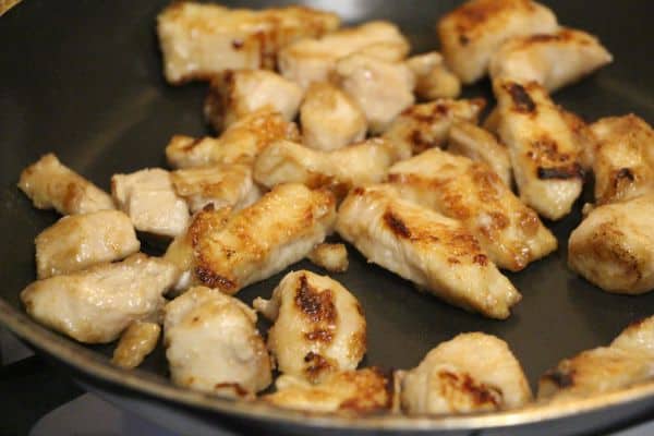 Cooking the outside of the chicken before adding it to the crockpot for the cranberry orange chicken.