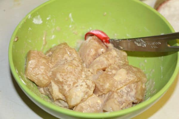 mixing up the foster farms chicken, preparing it for cooking in the pan. Making Cranberry Orange Chicken in a crock pot.