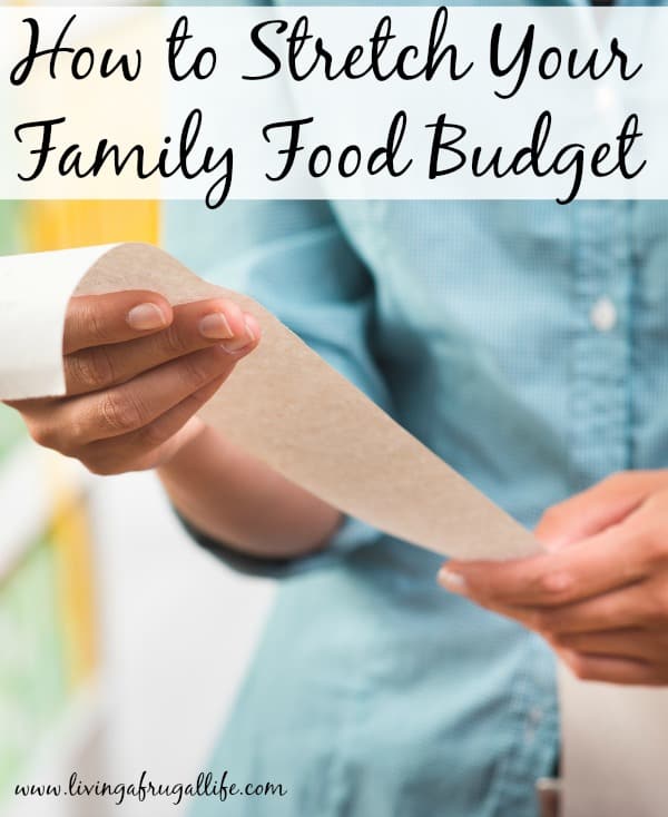 Unrecognizable woman in light blue shirt checking a long grocery receipt at store. Has a text overlay that says how to stretch your family food budget.