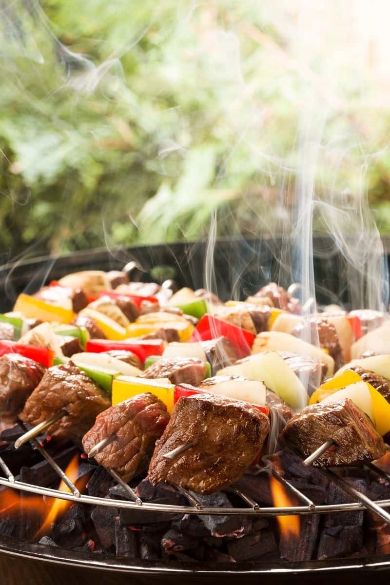 beef, peppers, and onions on the grill