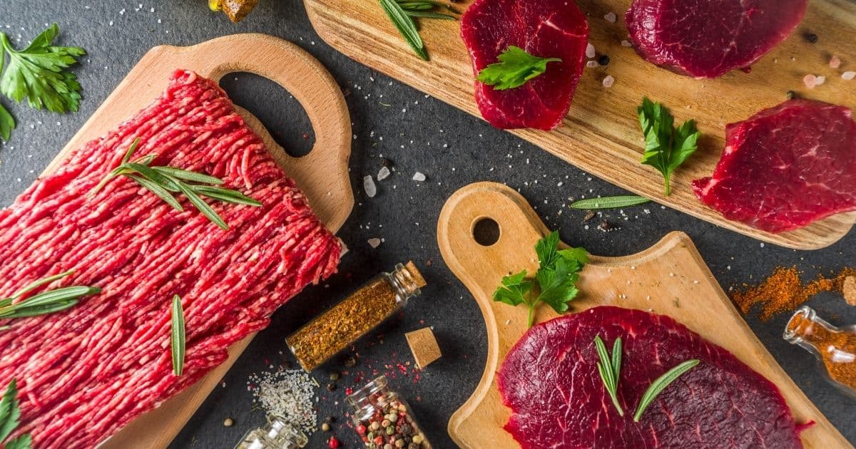 Wooden cutting boards with different cuts of beef.