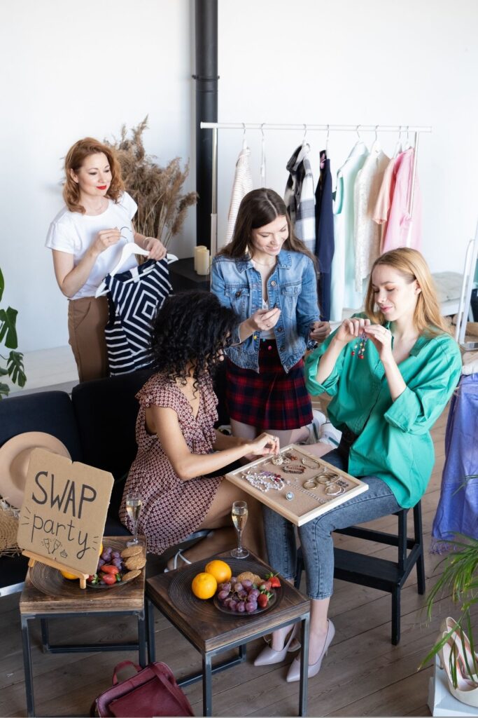 4 women swapping clothes with eachother.