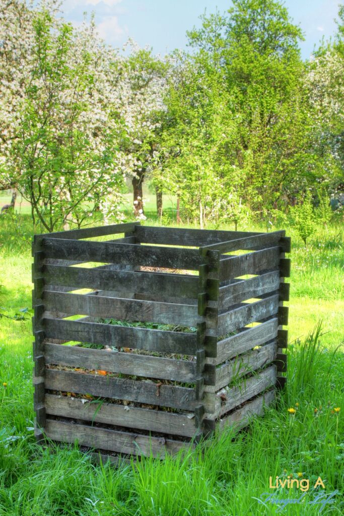 Wood planks nailed together to make a DIY compost bin