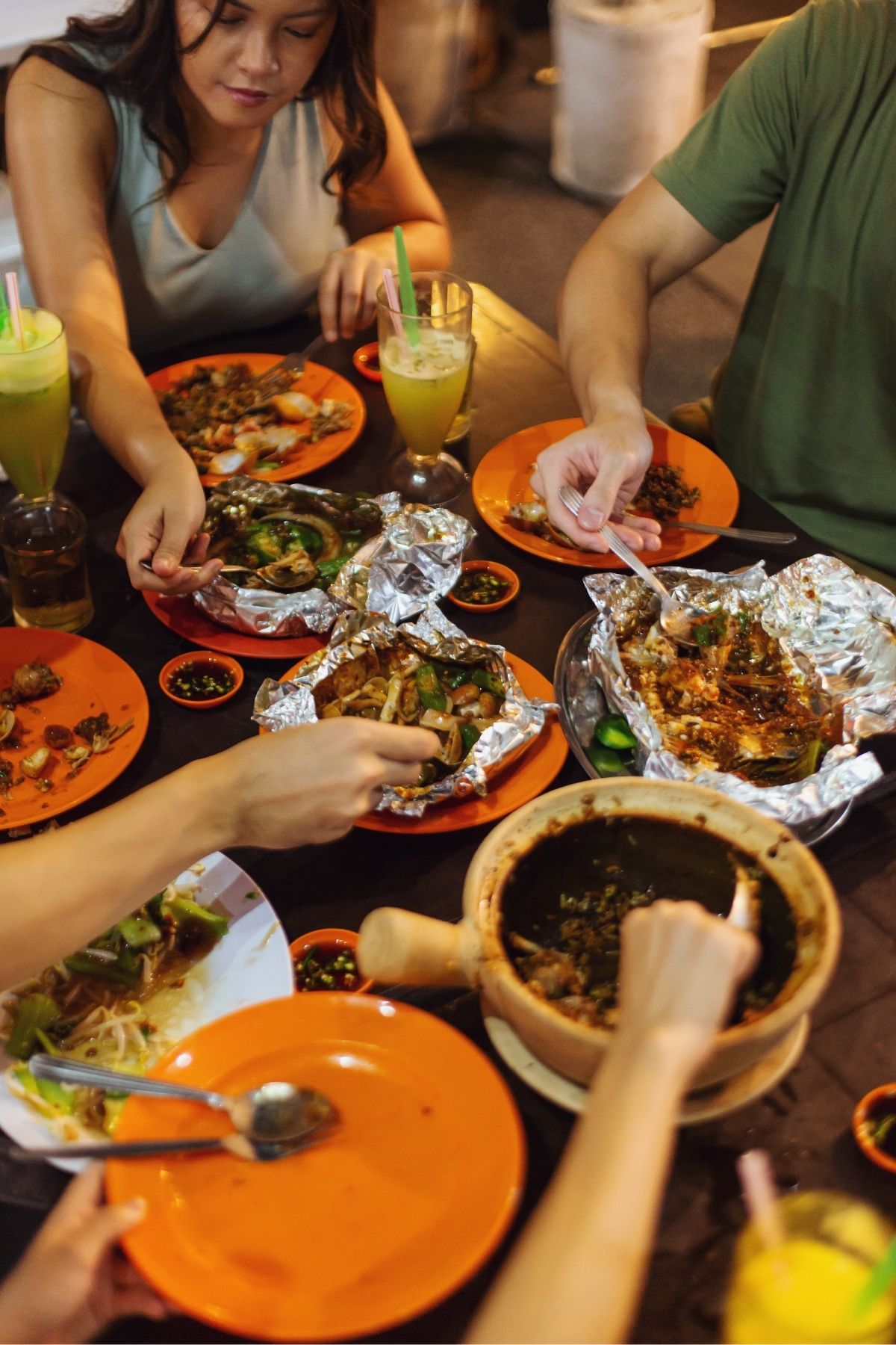 A family sitting around the table eating out.