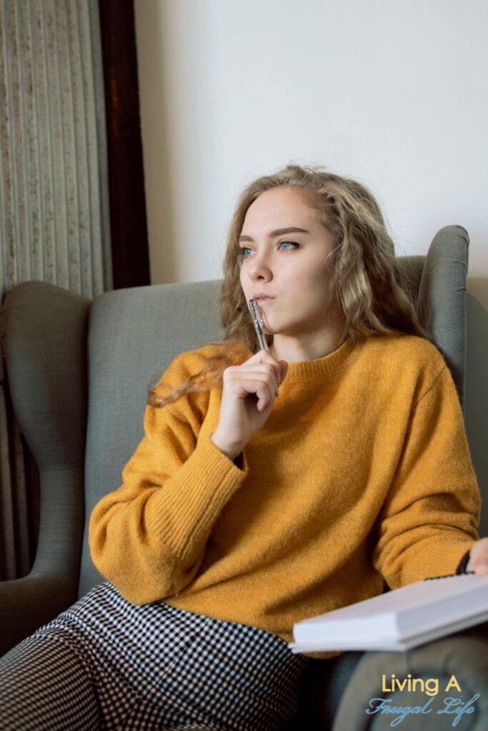 Girl sitting in a chair thinking.