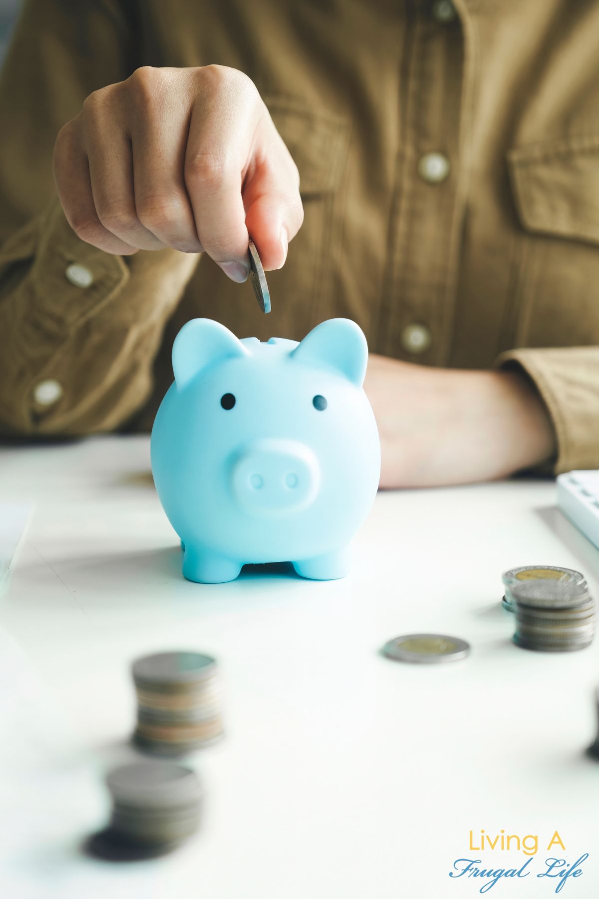 a man putting coins in a piggy bank for saving.