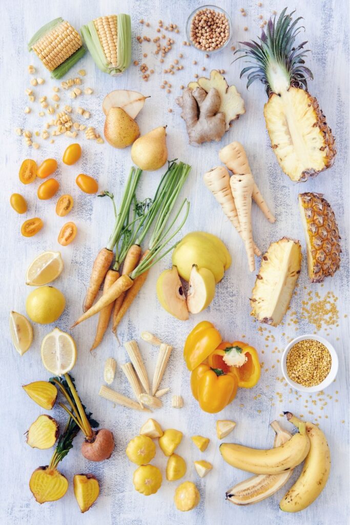 A table full of fruits and vegetables and spices.