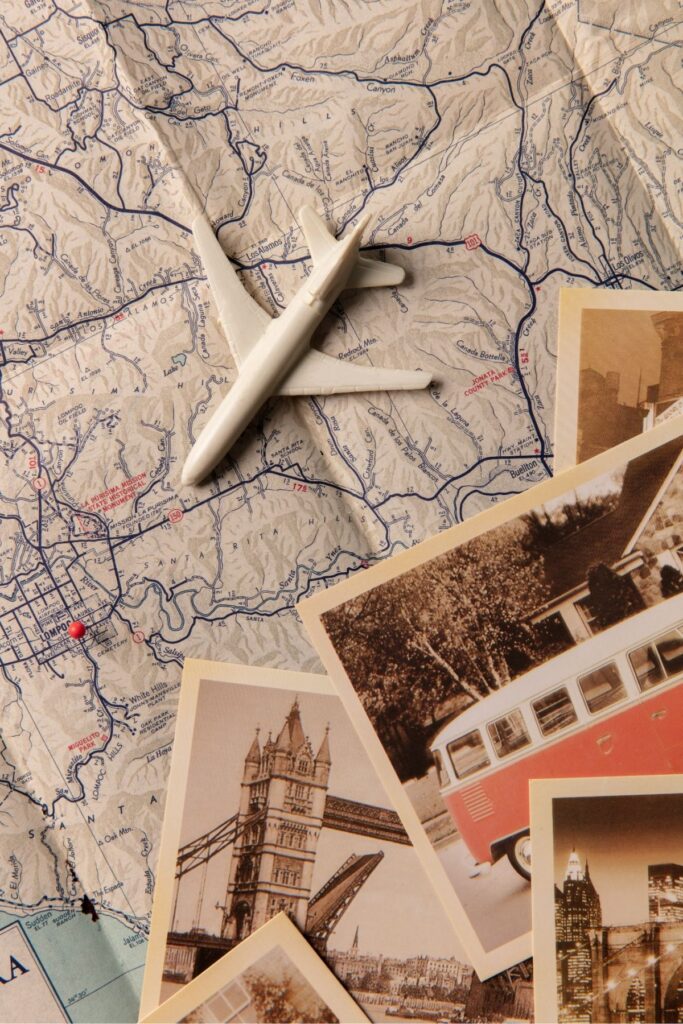 a map with a toy airplane and photos on top.
